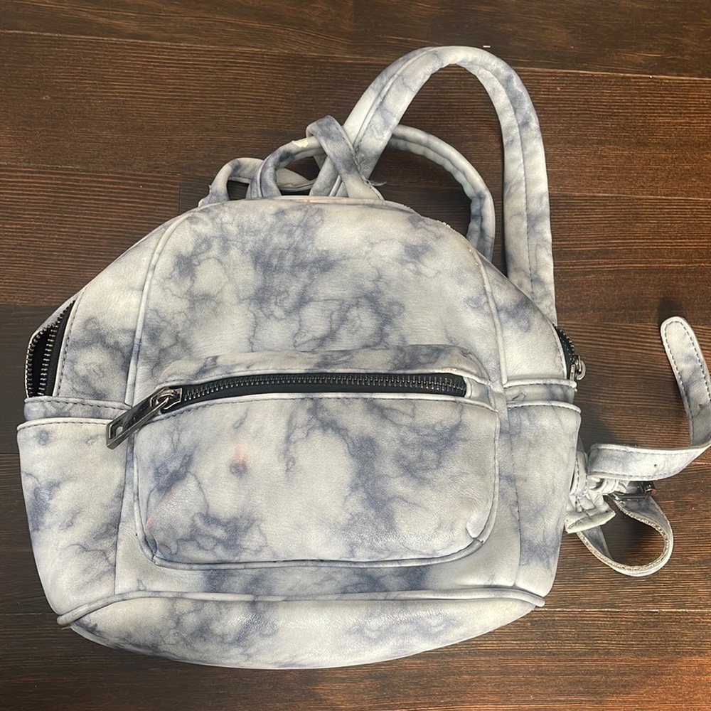 Marbel blue small backpack. Easy to carry around with stores a lot of things.